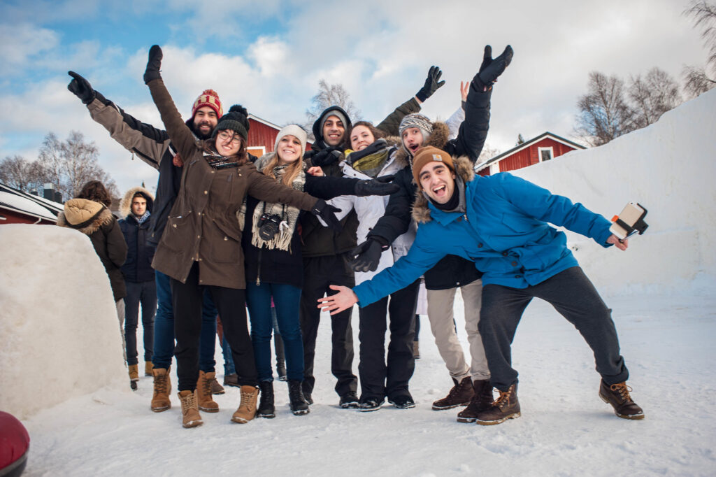 happy faces wearing warm clothes in Lapland