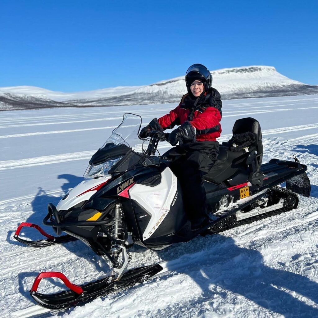 zoom up a person sitting on a snowmobile