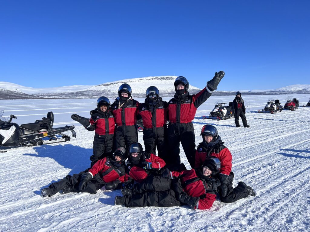 people wear winter overall on snowmobile trip
