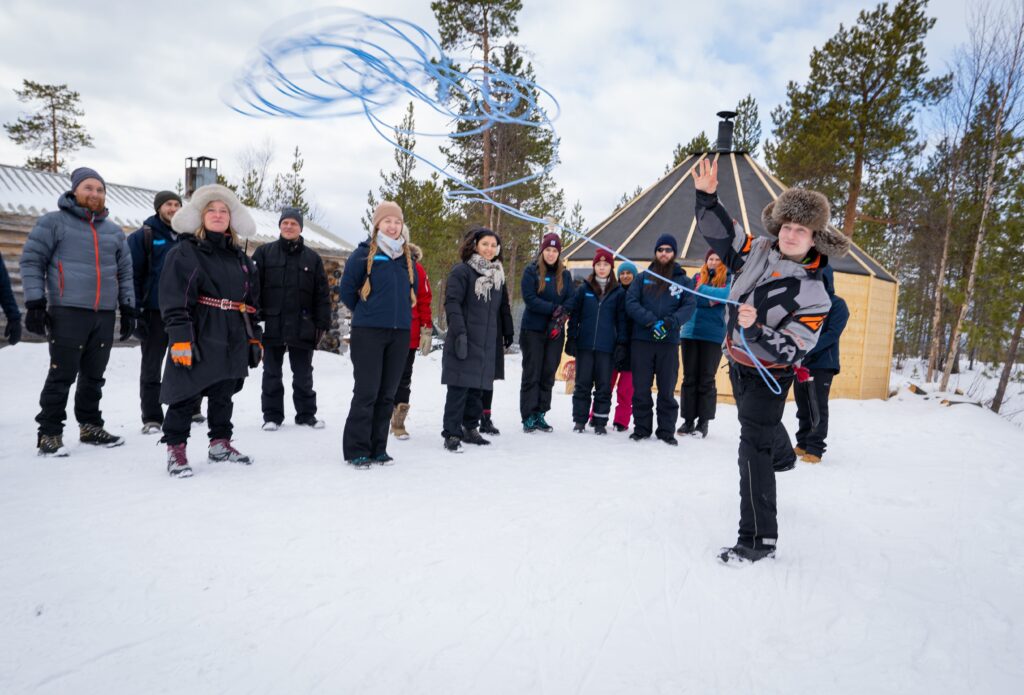 Sami reindeer herder throwing the lasso rope