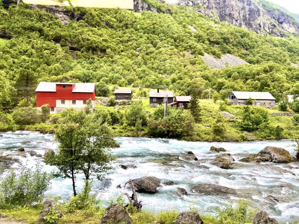 scenery on the way to flam, house and crystal clear river